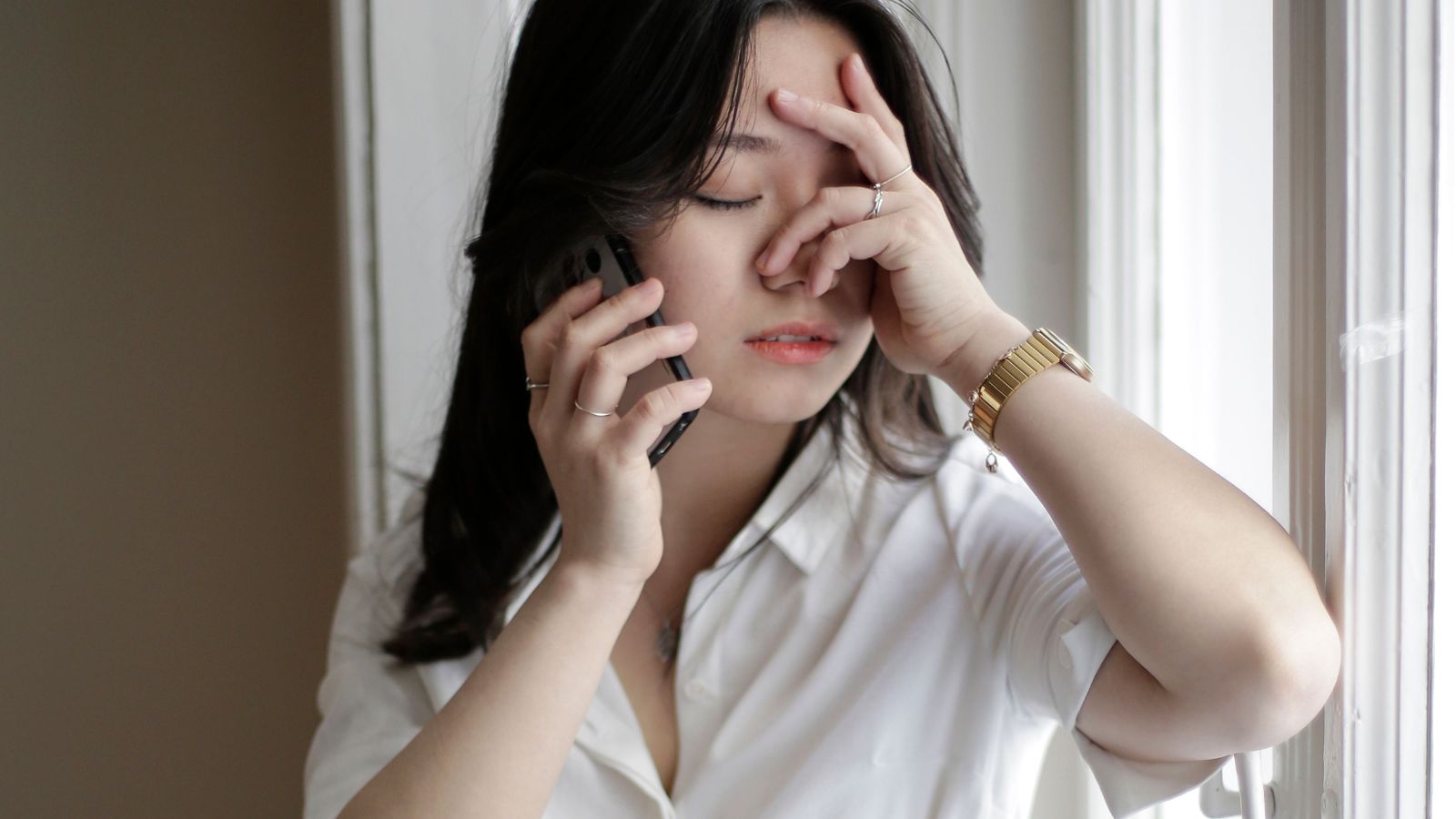 Woman talking on the phone feeling upset