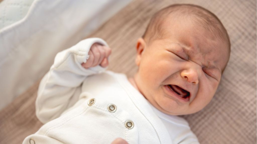 Baby crying while lying on the crib