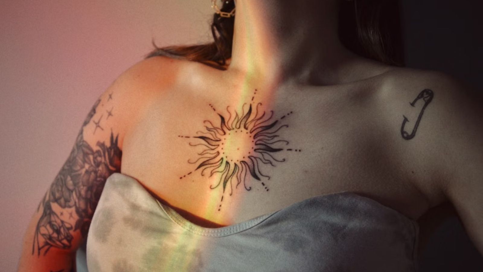 She Tried to Honor Her Son’s Wife With Permanent Ink—His Instant Reaction Broke Her Heart Woman with a sun tattoo on her chest