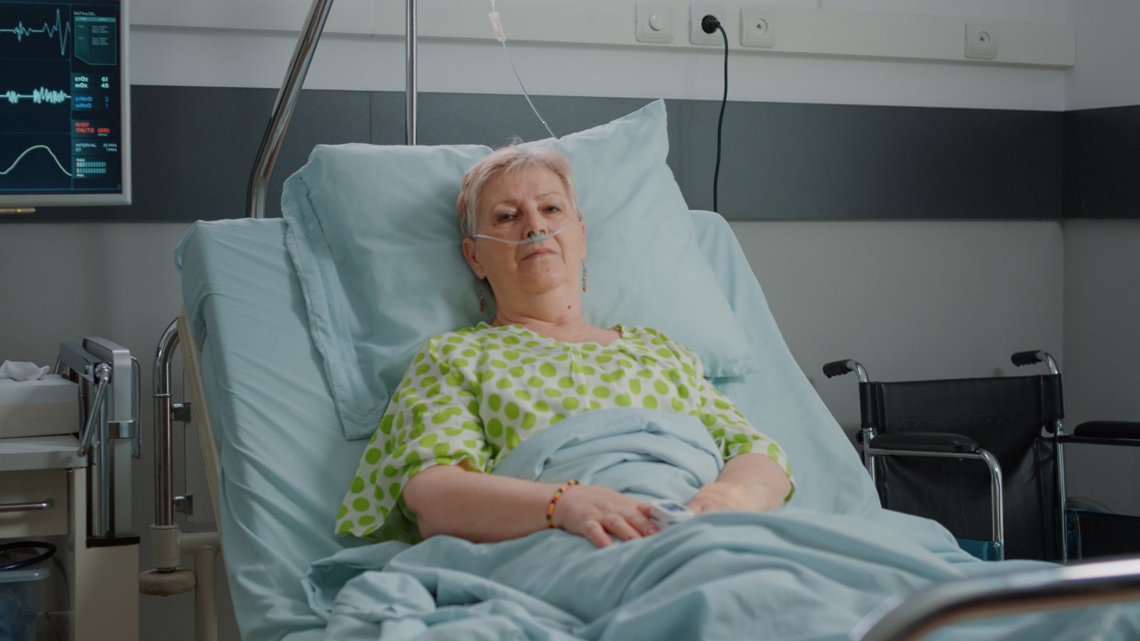 Old woman lying on a hospital bed