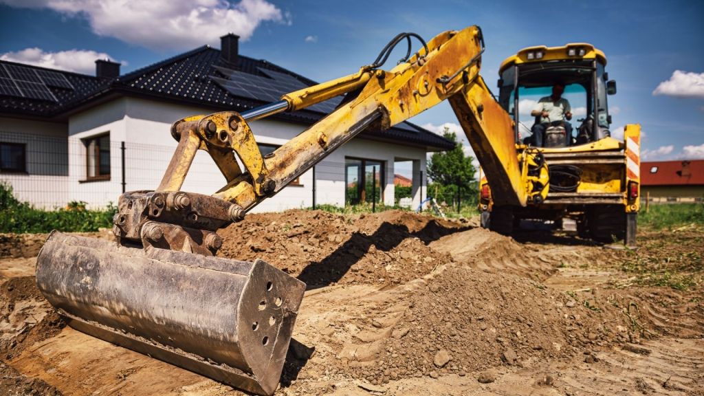 excavator in house's backyard