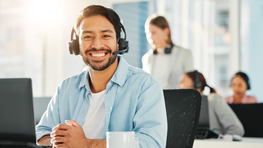 smiling man working in a call center