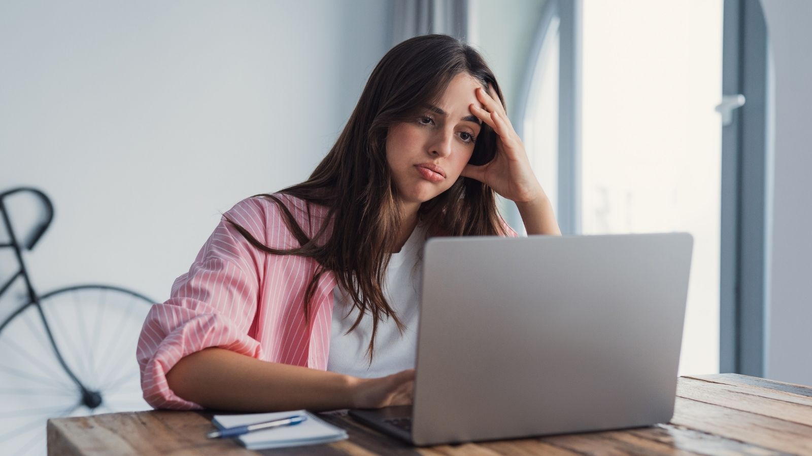 Their Landlord Promised Free Rent for Repairs, Then Demanded a Year of Back Pay frustrated woman looking at her laptop