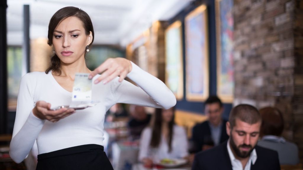surprised waitress looking at customer's bill