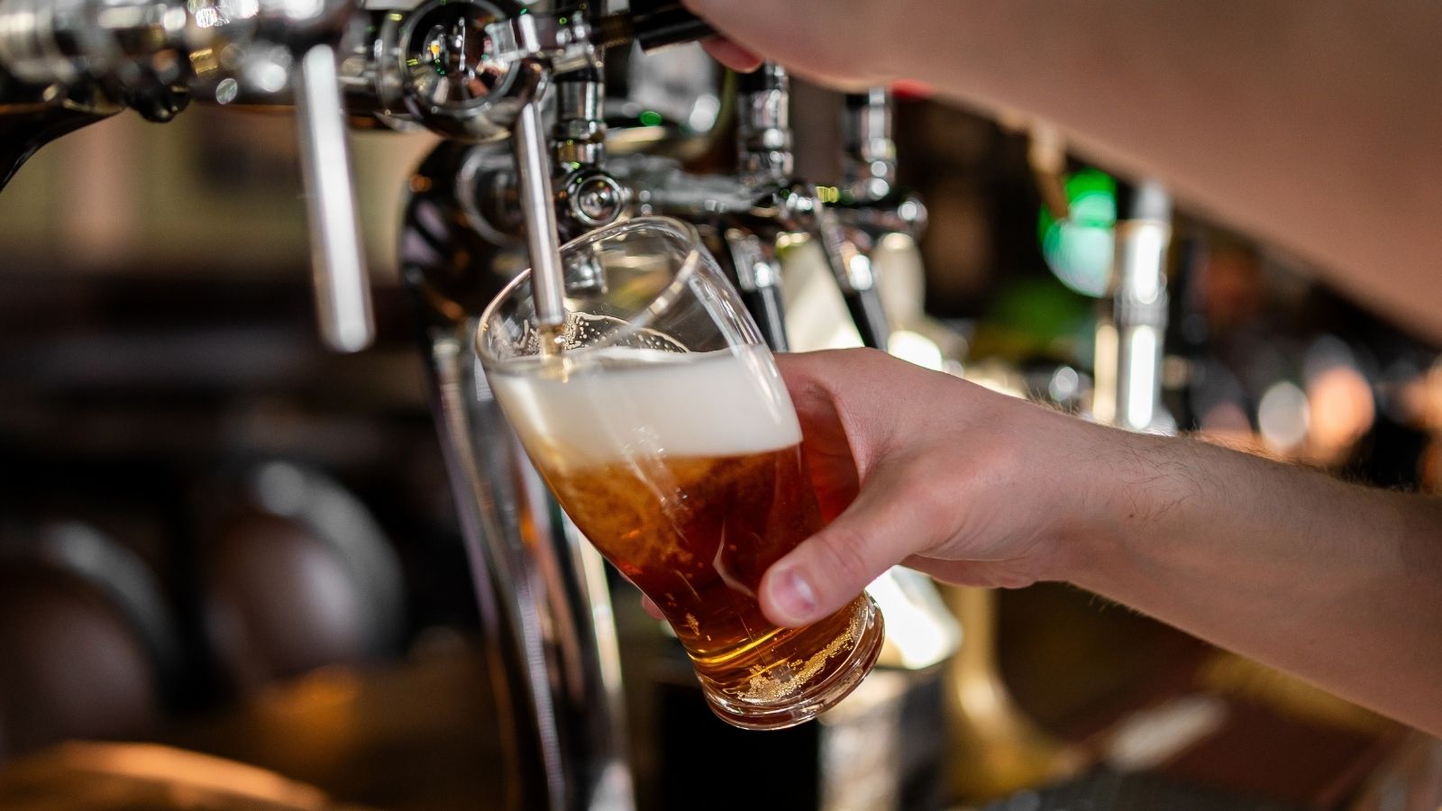 bartender pouring a pint of beer