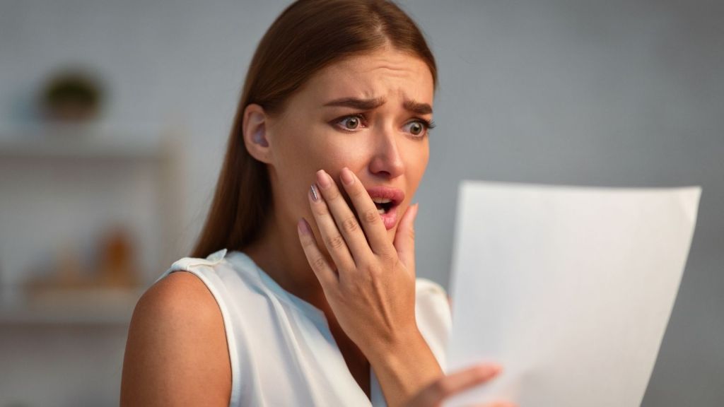 stressed out woman reading a letter