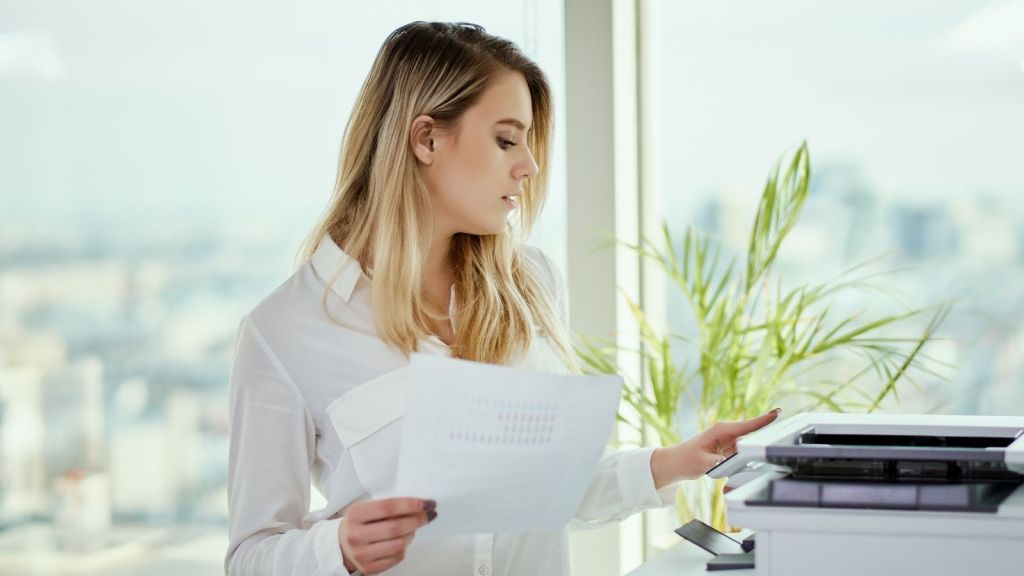 young businesswoman using a printer