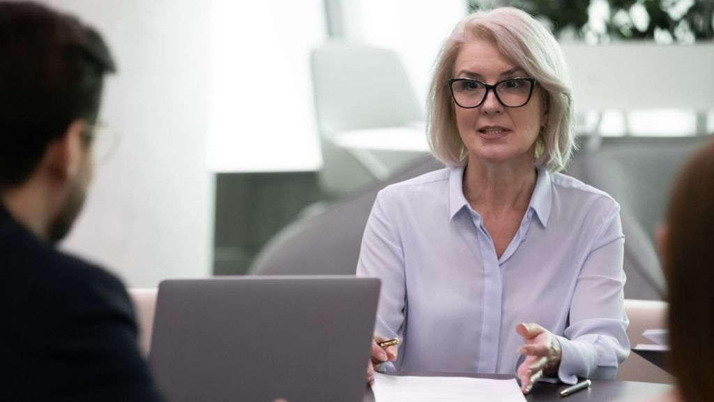 female boss talking to two employees