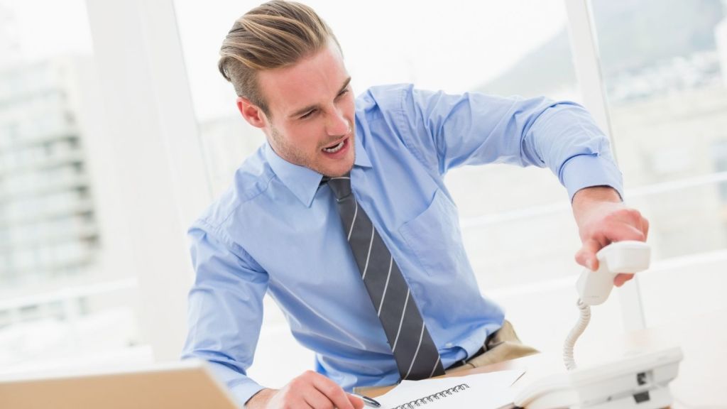 angry businessman hanging up the phone