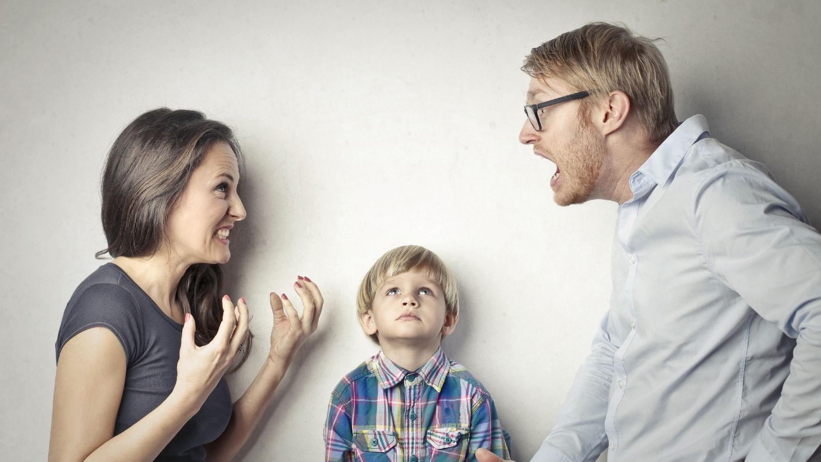 Nurse Has a Chance to Work Overtime, but His Wife Isn’t Happy About the Impact at Home couple argues while little boy looks on