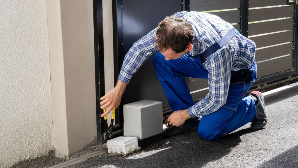 repair man fixing automatic gate