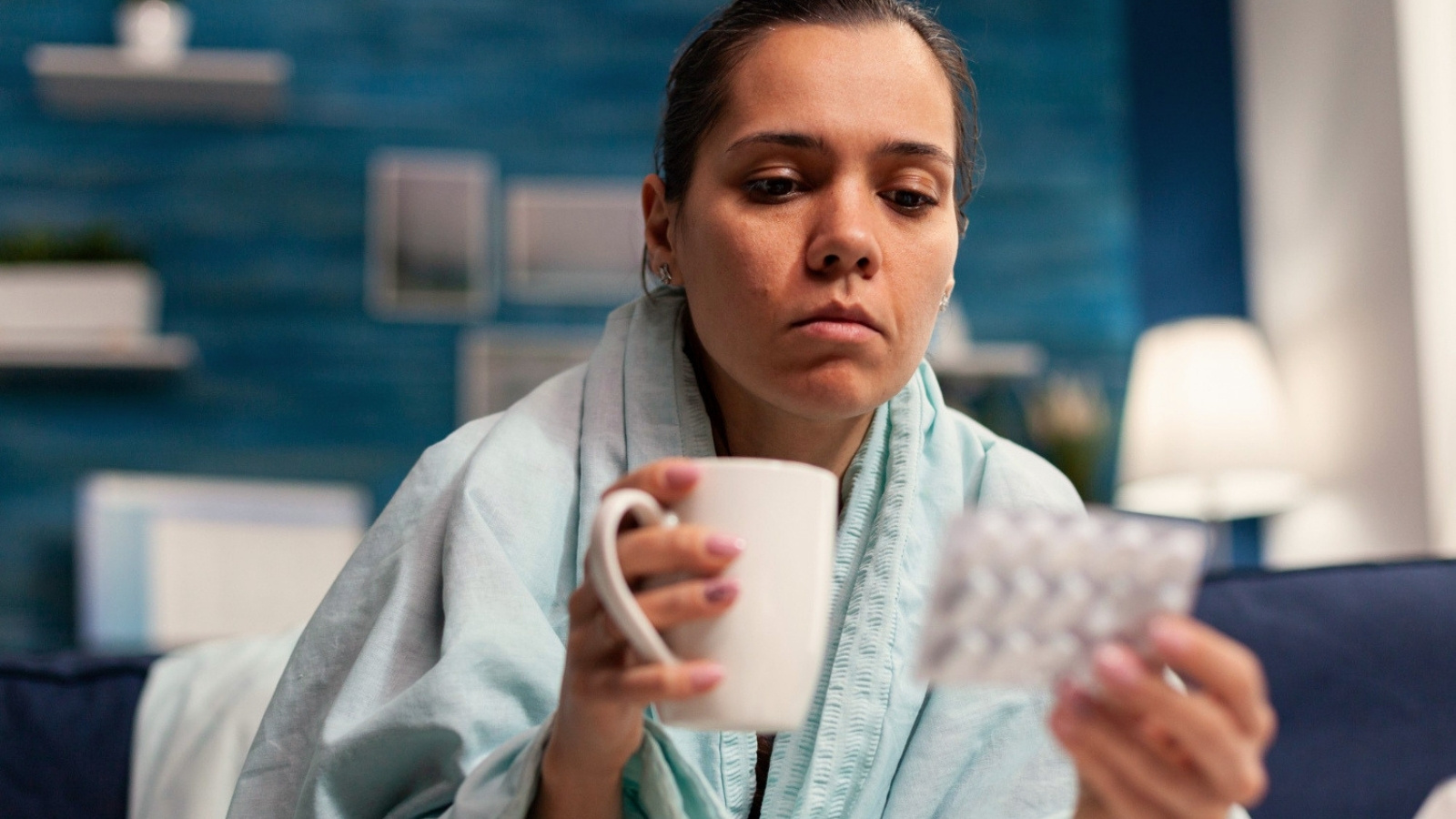 Sick woman looking at medicine