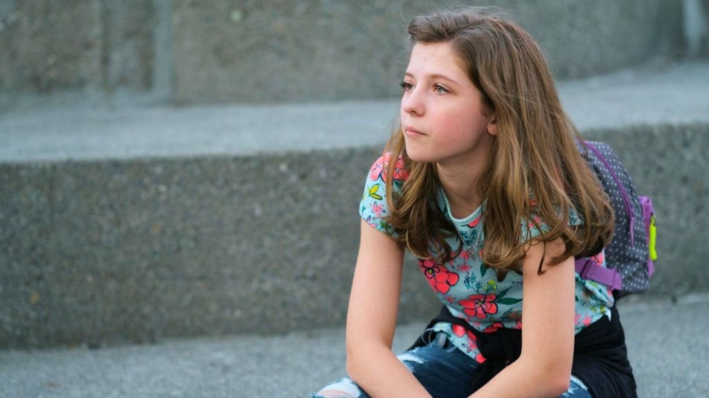 Angry teen girl sitting at stairs