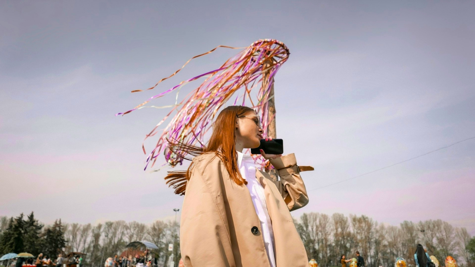 Woman using phone outside at festival