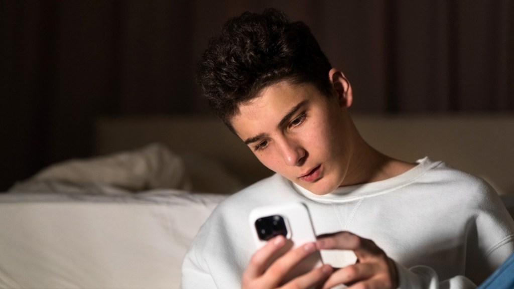 Pensive man looking at his phone