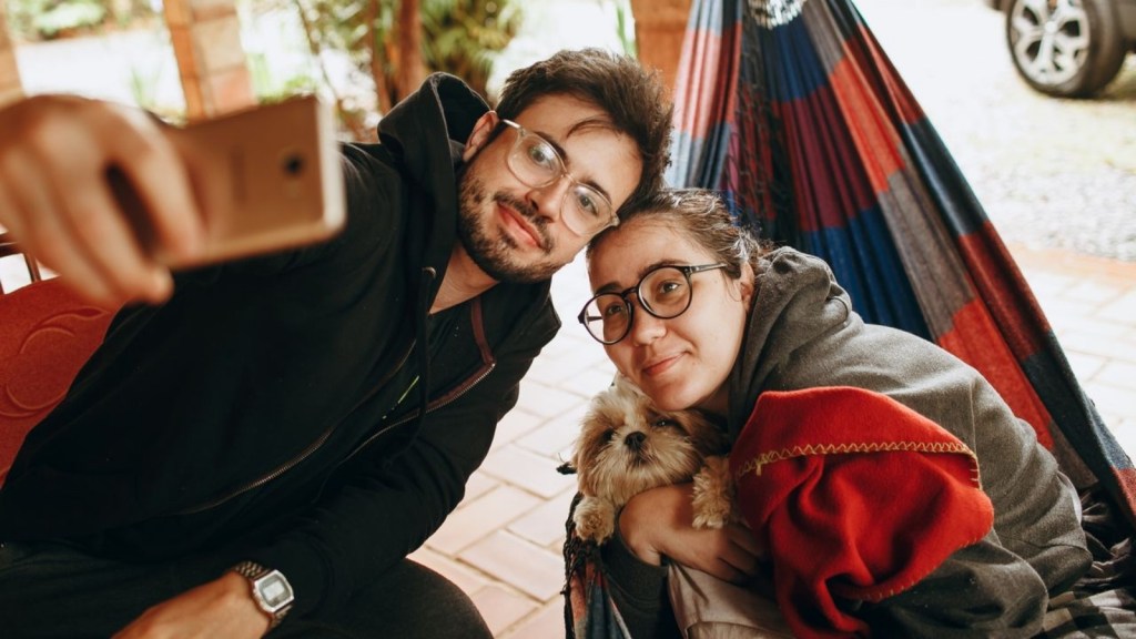 Couple taking a selfie with a dog