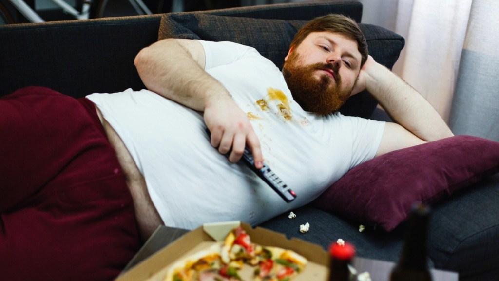 Man watching TV laying on the couch