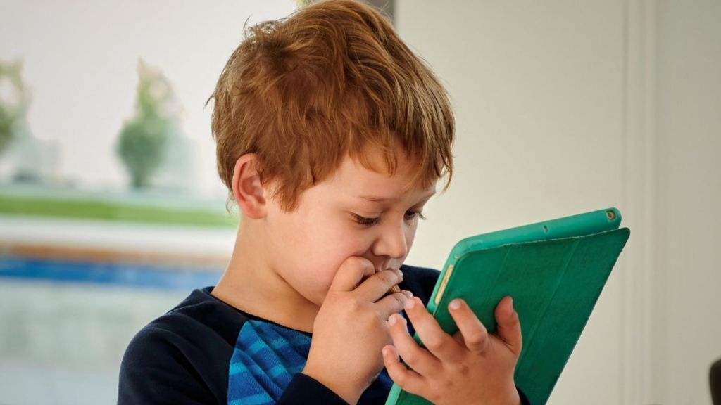 Boy using an ipad indoors