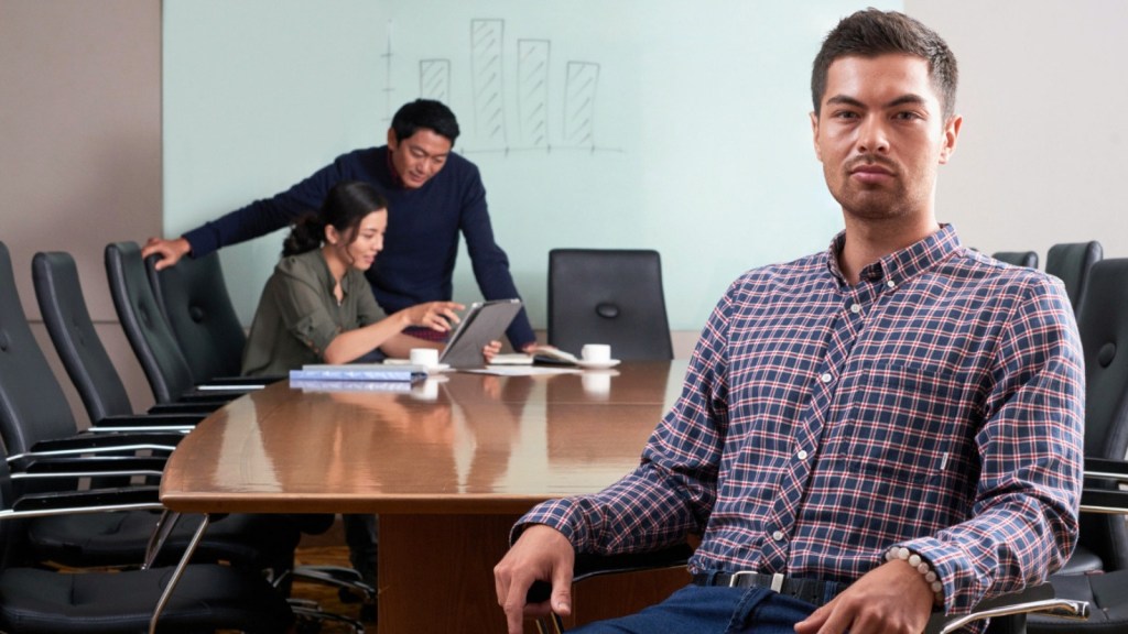 Male employee at office with coworkers