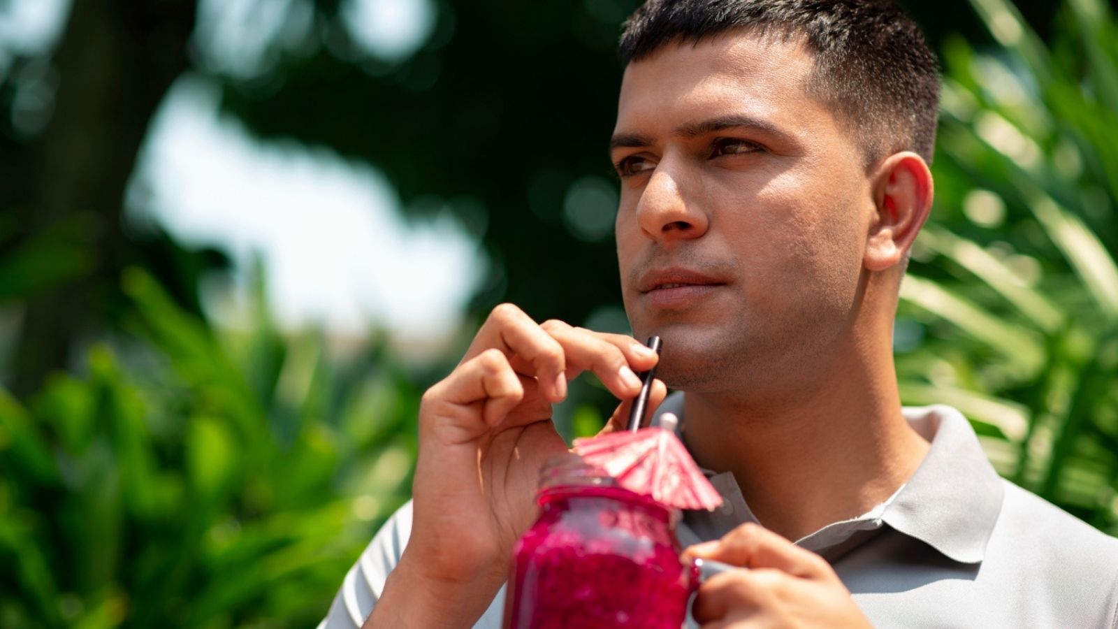 His Coworker Is Thriving in the Corporate World While His Own Dream Job Is Handing Out Free Smoothie Samples Intense looking man holding a smoothie