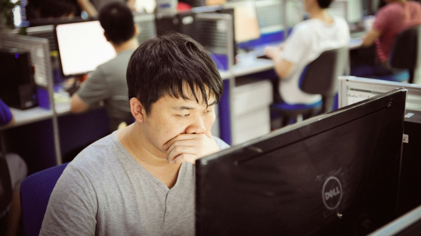 Asian man using a dell computer