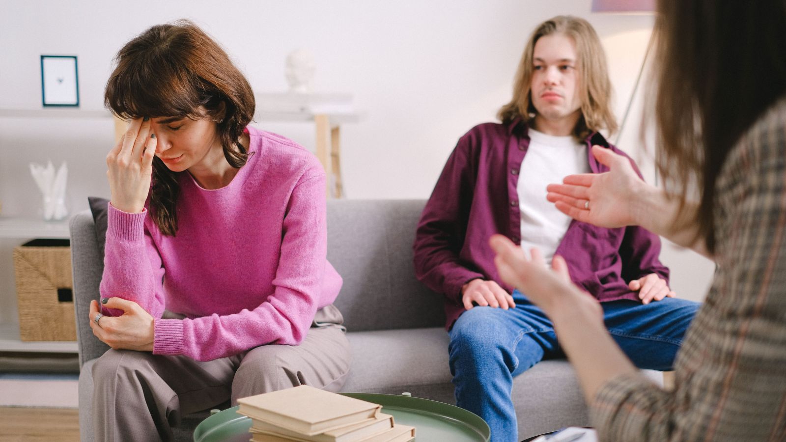 How Do We Choose?: Parents Face Impossible Dilemma Over Daughters Back to Back Convocations Sad woman in pink sweater