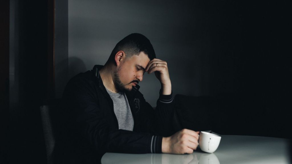 Sad man holding his head