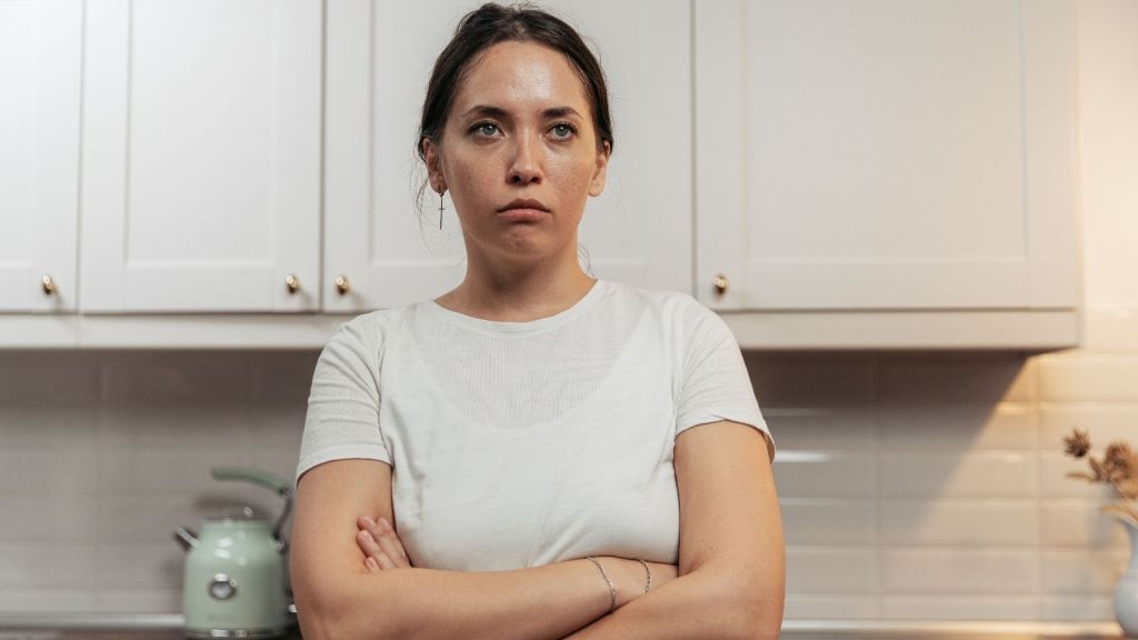 Woman frowning in kitchen