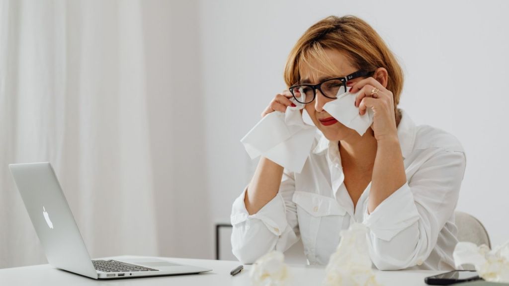 Woman crying in front of laptop