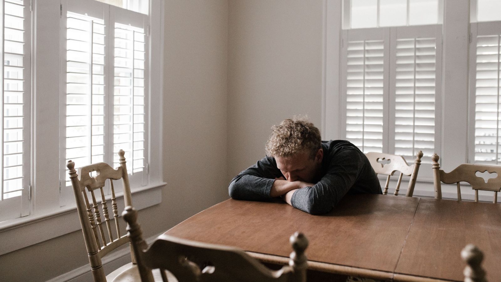 A Lost Passport Shattered Their Visa Sponsorship And Left a Couple Staring Down a Sudden, Forced Separation Sad man lying on a table