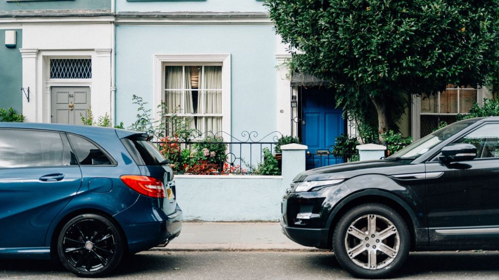 Vehicles parked on the street in front of houses