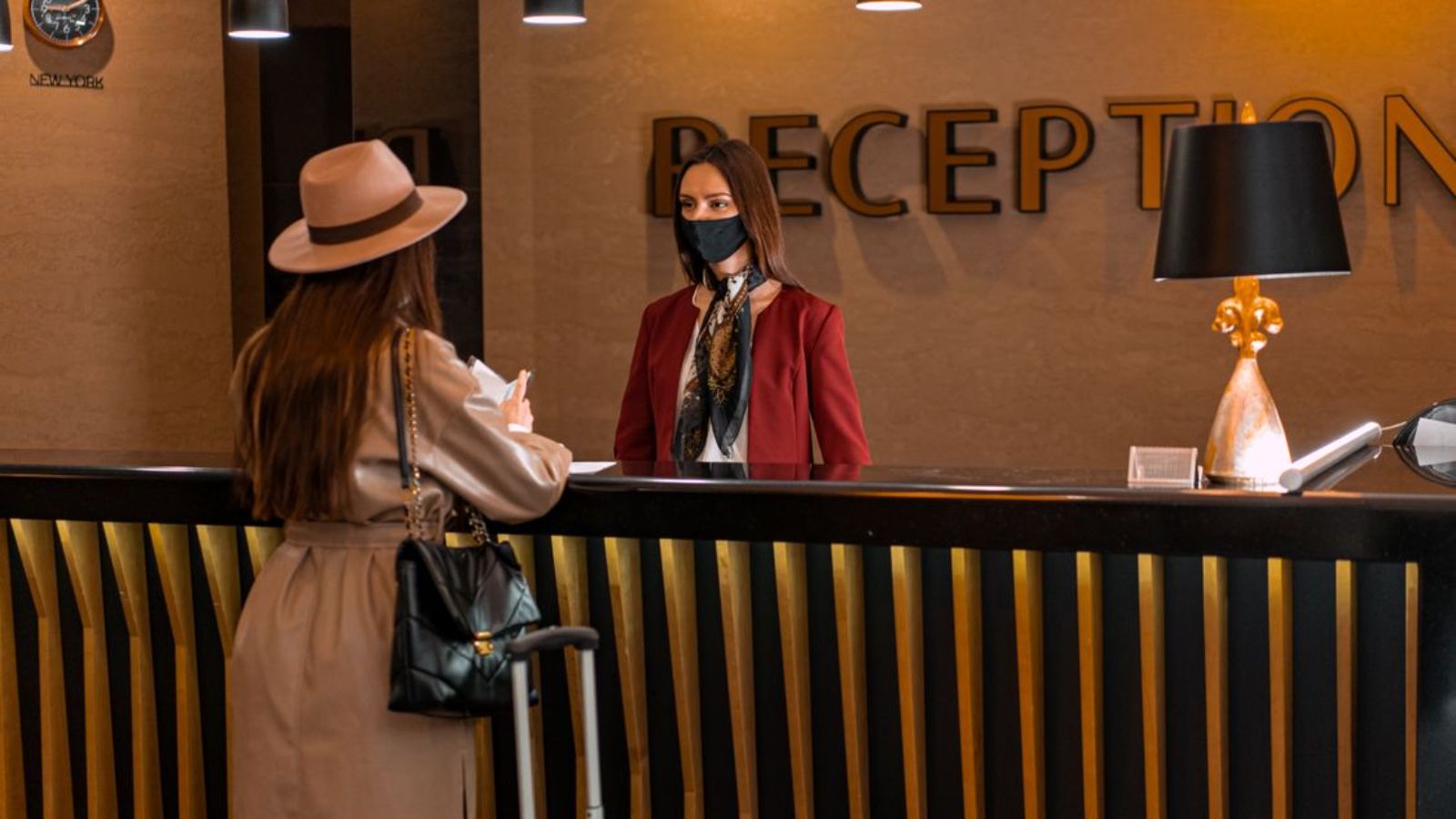 She Told a Guest Shed Accidentally Booked Two Hotel Rooms, And The Guest Blamed Her for Not Calling to Warn Her First Woman checking in at hotel reception