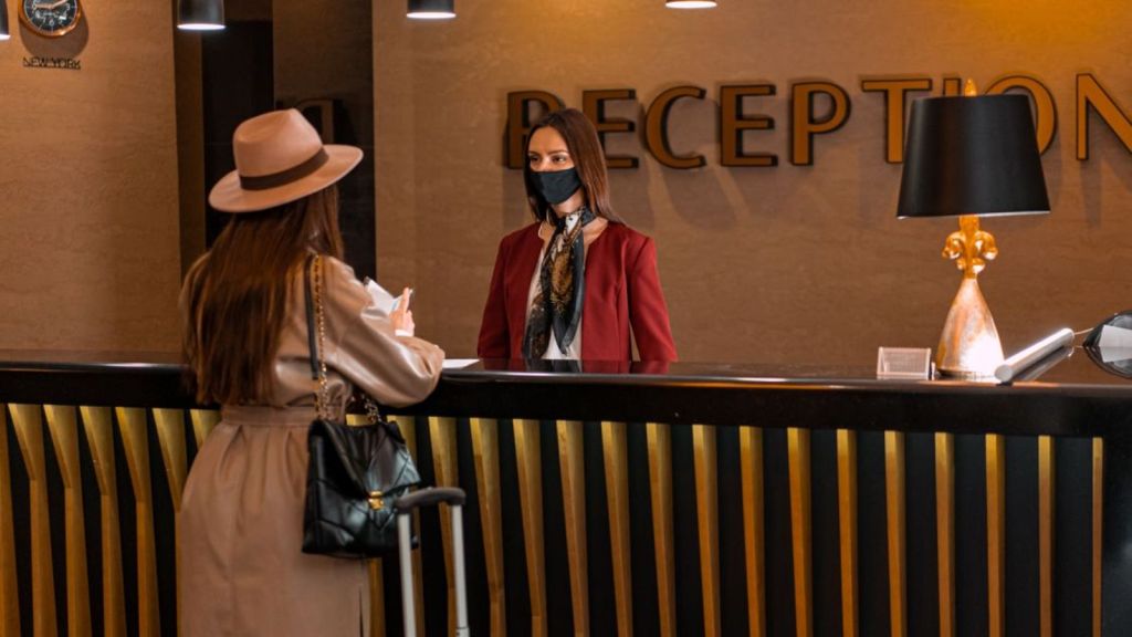 Woman checking in at hotel reception
