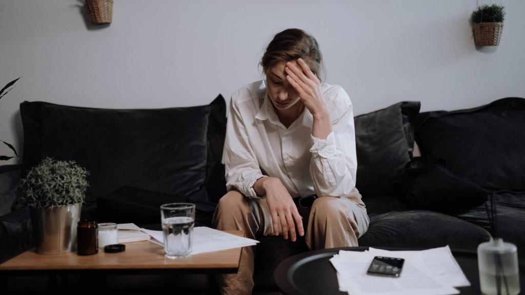 Woman looking stressed on couch at home