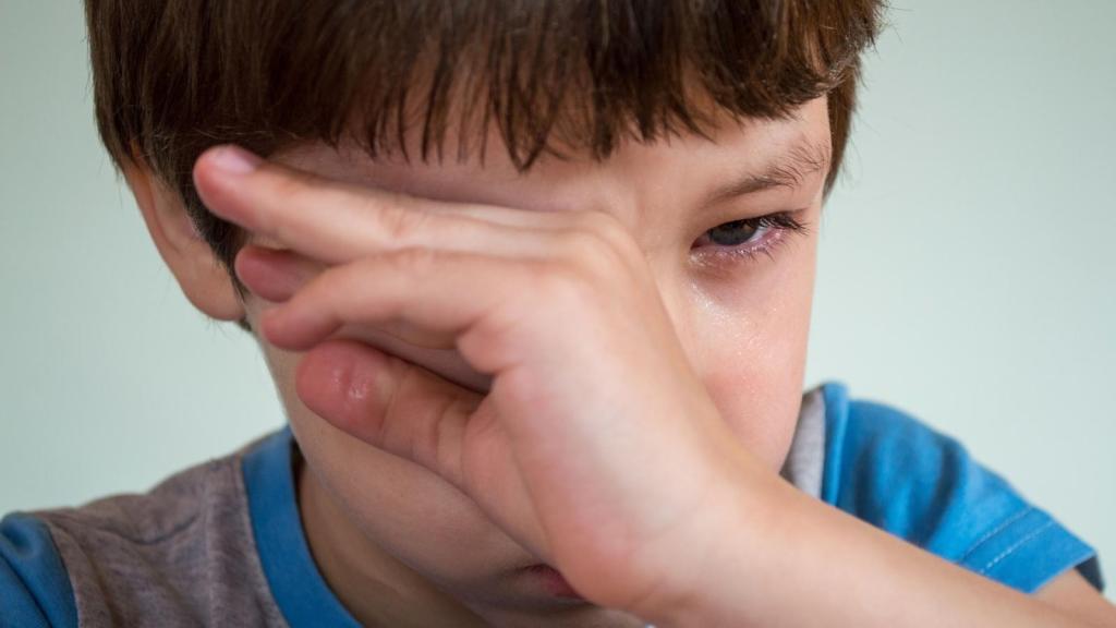 angry little boy wiping his tears