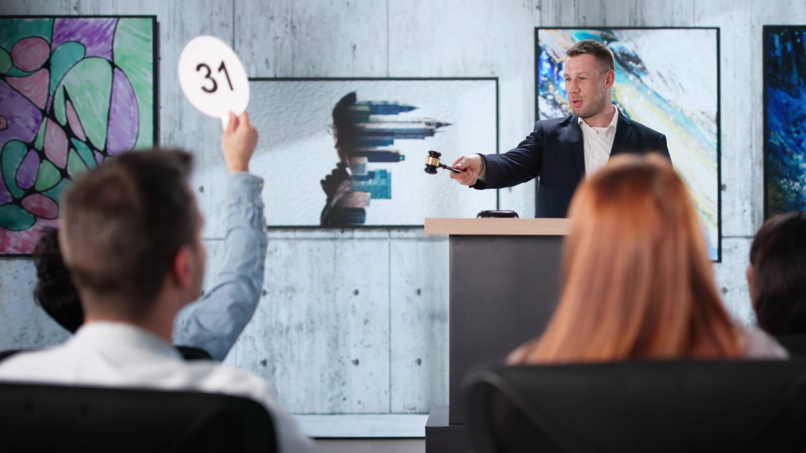 An Obnoxious Bidder Dominated the Auction All Day. One Determined Buyer Waited Until the Final Moment to Settle the Score. man at an auction