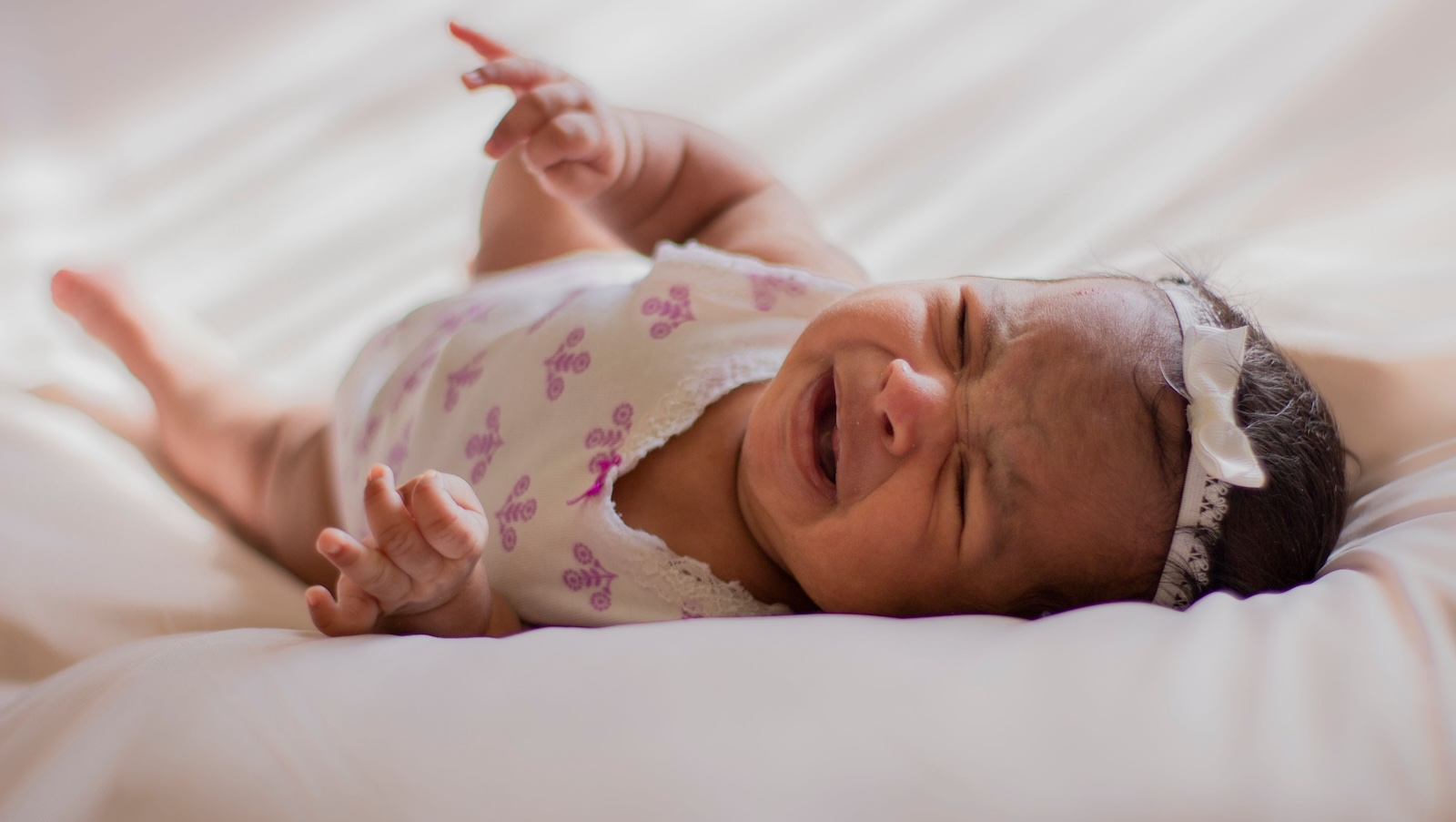 Parents Clash After Mom Asks for Help With Nighttime Wake Ups and Dad Feels Pushed Away newborn baby girl crying in bed