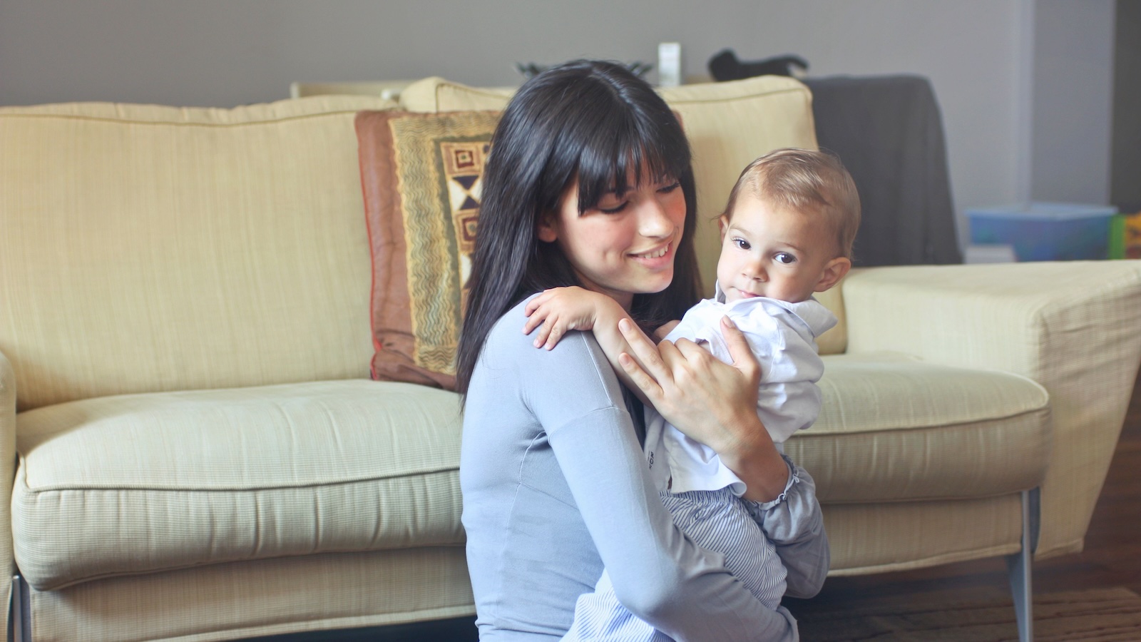 woman holding/babysitting a little boy