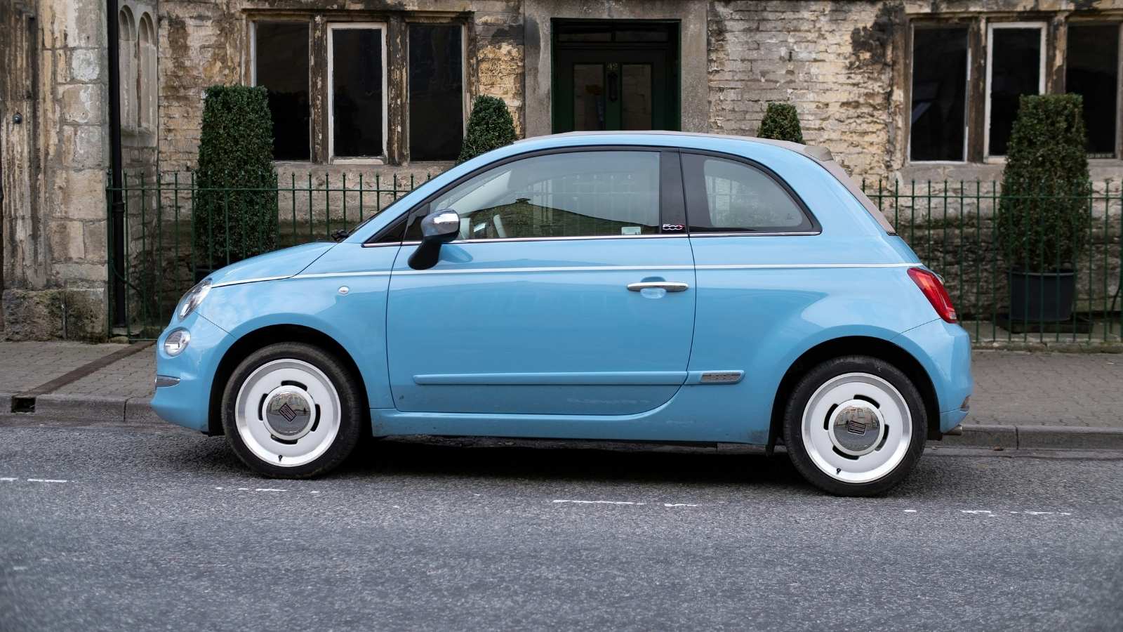 blue car parked in front of house