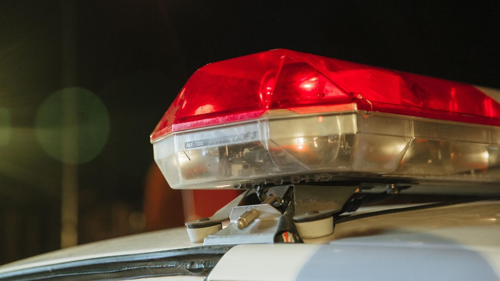 Her Neighbor Called the Cops Saying Her Dog Barked Nonstop for an Hour — Her Ring Camera Had a Very Different Story closeup of red cop car lights