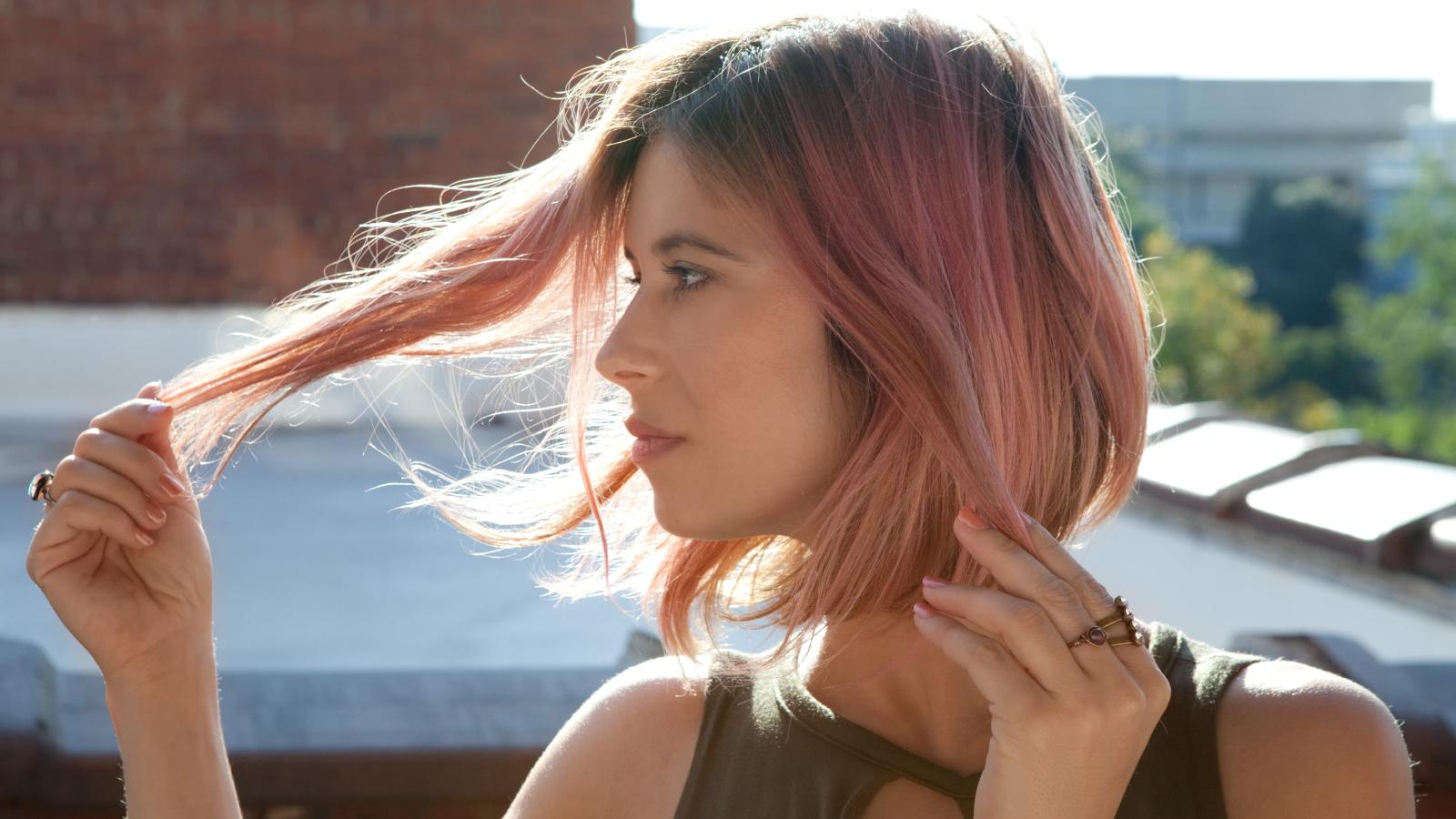 woman looking at her hair