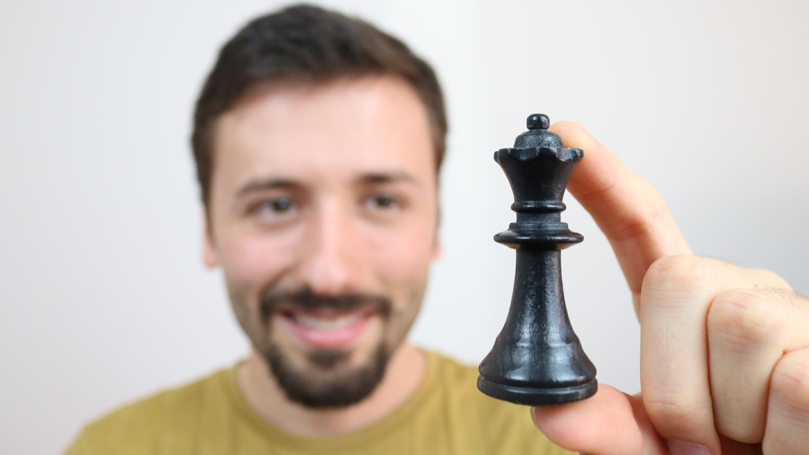 Man Takes Chess Piece From Bad Roommate After Difficult Living Situation Comes to an End man holding a chess piece