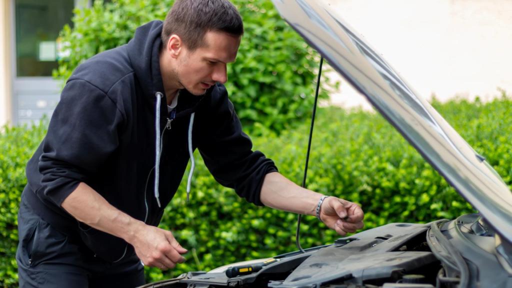 man checking his oil