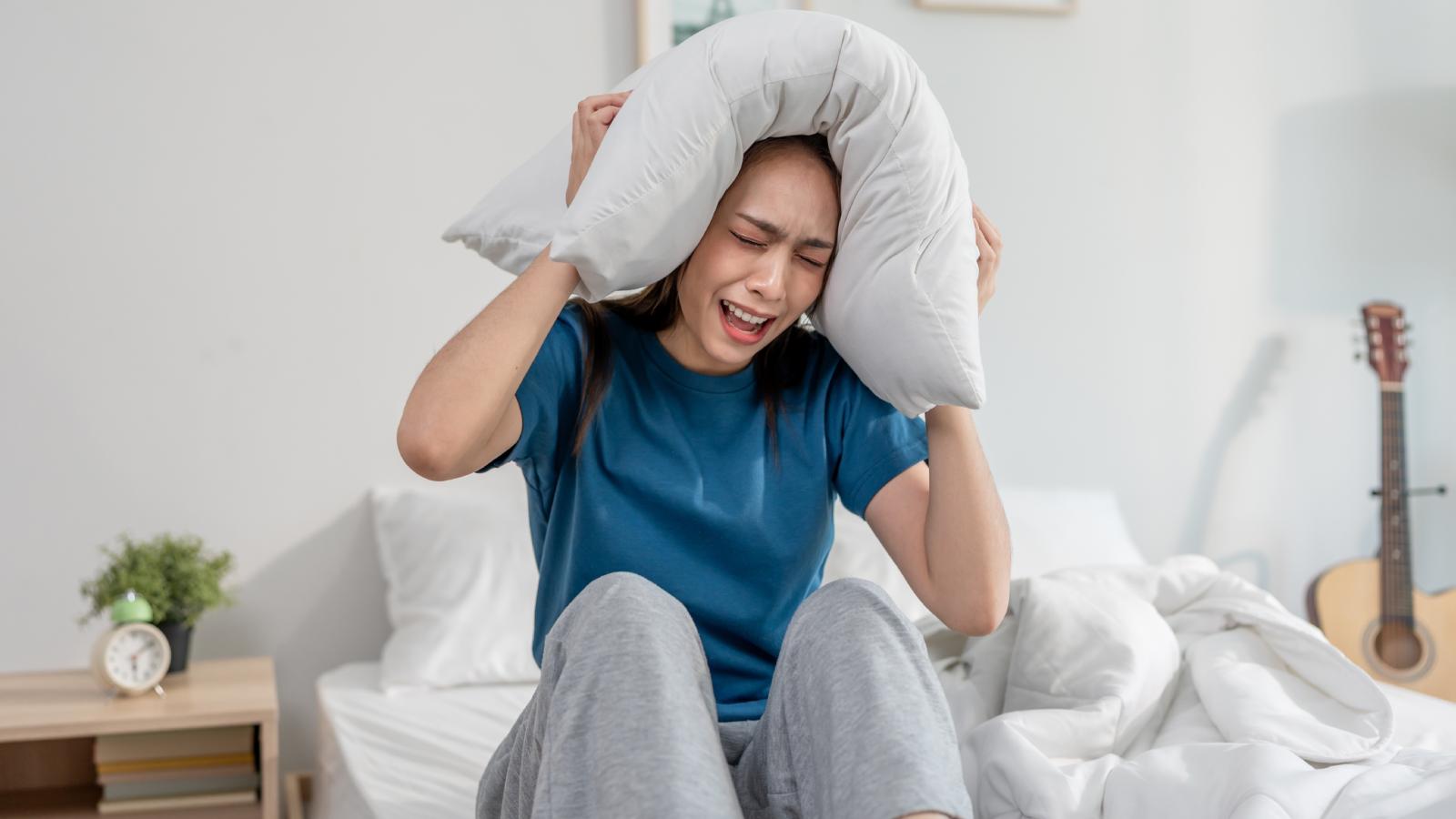 Her Roommates Keep Creating Drama Over Nothing — Shes Done With It and Counting Down to Moving Out woman with a pillow over her head