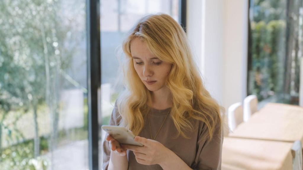 concerned woman looking at her phone