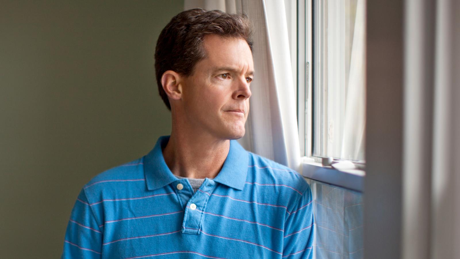 His Neighbors Fight Constantly and Let Their Kids Run Wild—Now He Doesn’t Know What Else to Do man looking out a window