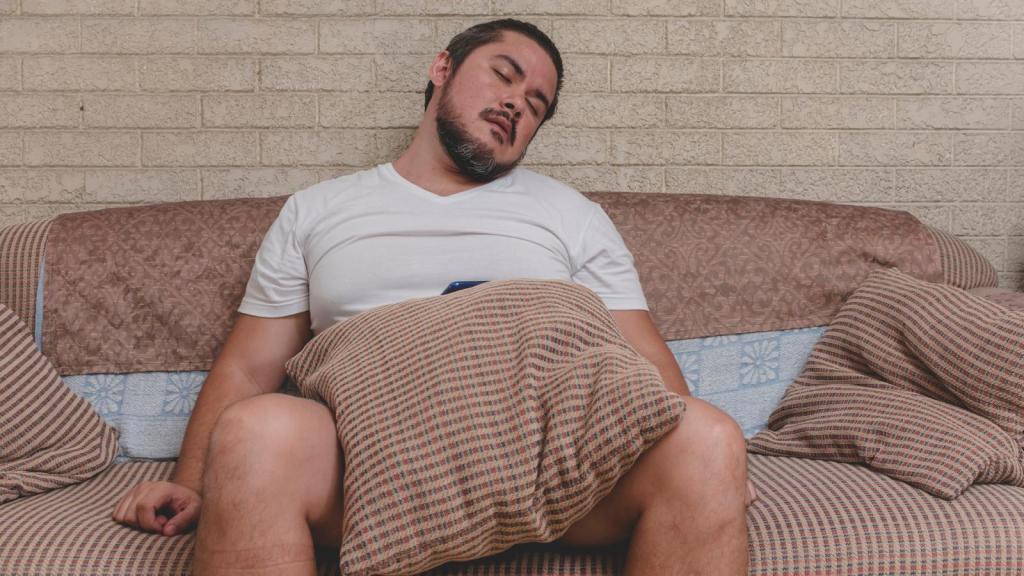 man sleeping on a couch