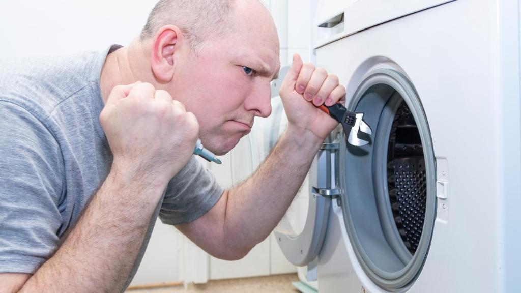 man working on a washing machine