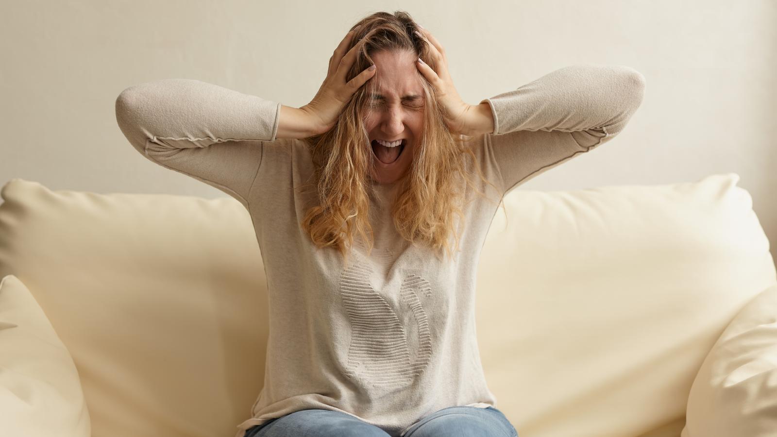 After Years of Quiet Living, One New Neighbor Has Made Their Apartment Feel Impossible to Enjoy woman covering her ears