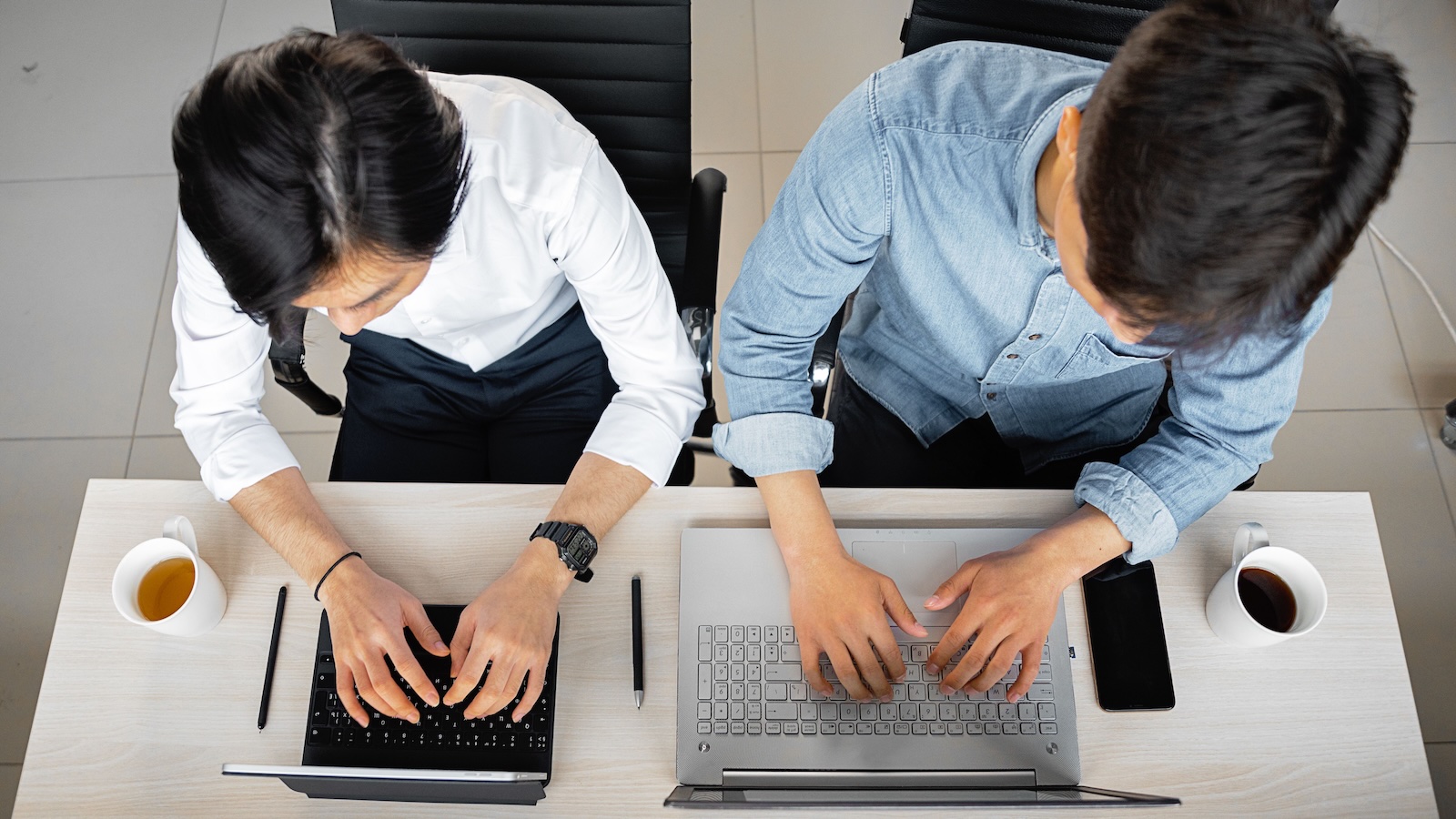 Office Avoids One Difficult Coworker, But His Behavior Keeps Landing On The Same Person two men colleagues working on computers side by side